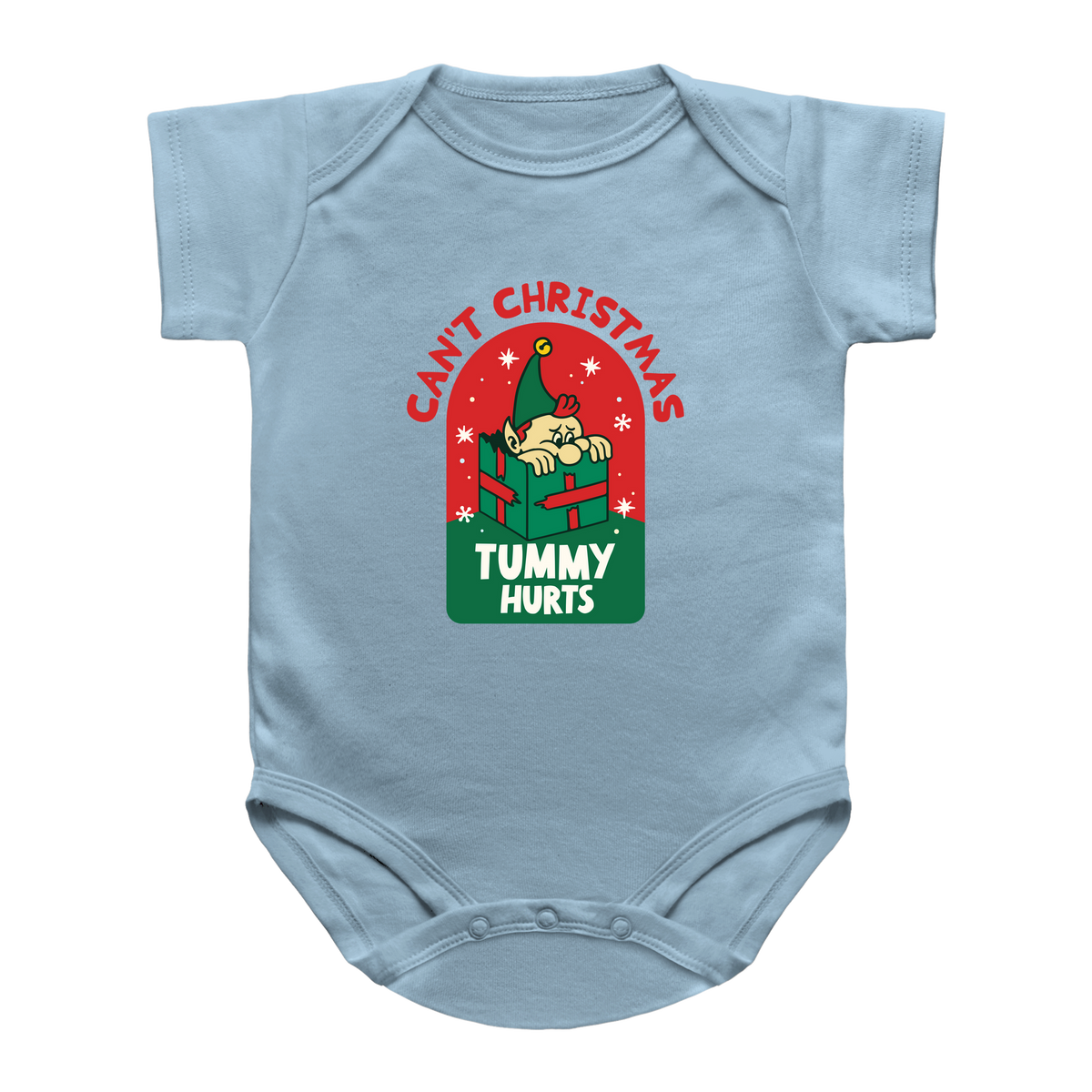 A light blue baby bodysuit featuring a Christmas-themed graphic on the chest. The graphic shows a cartoon baby peeking out of a green gift box under the red text &