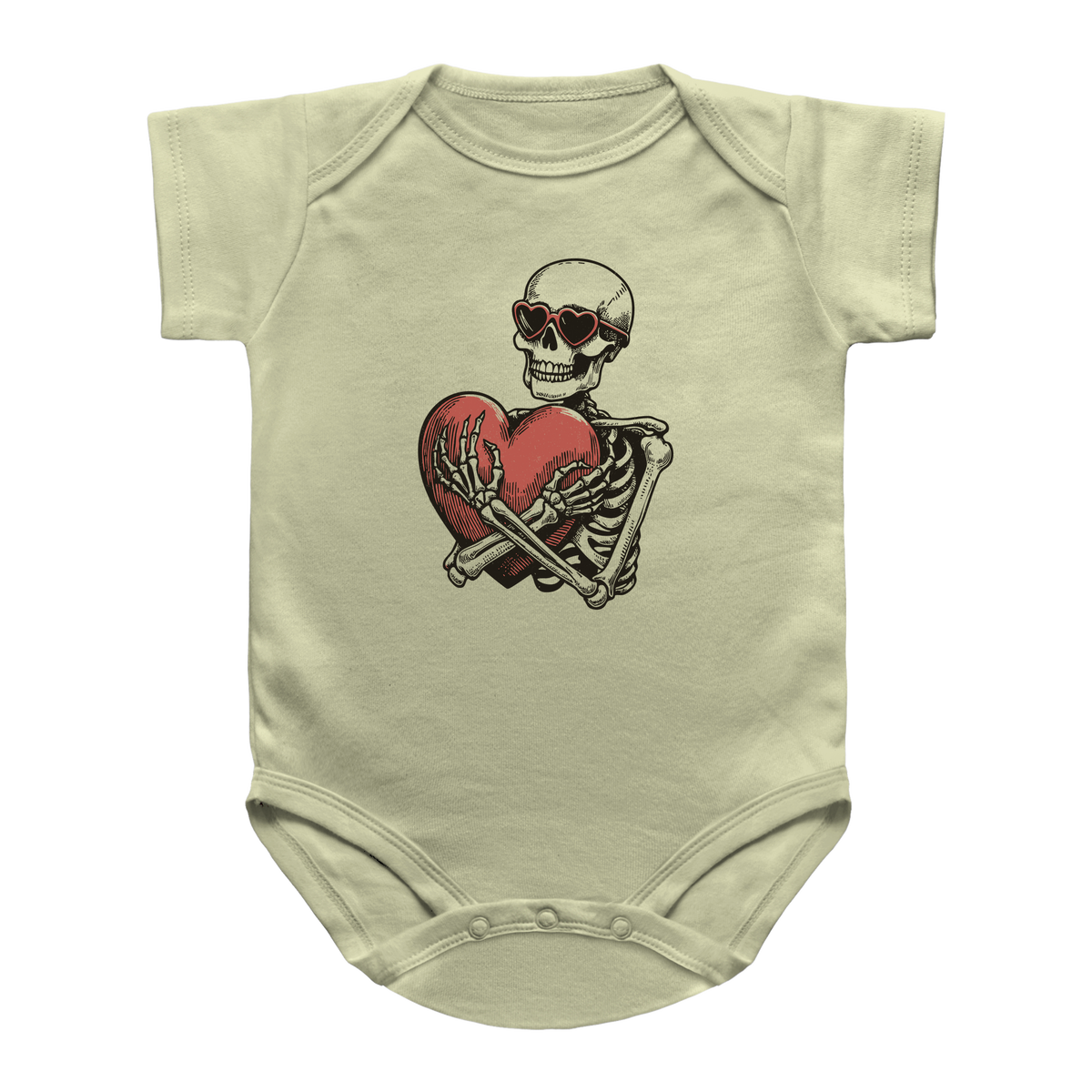 A beige infant onesie featuring a graphic print of a Halloween skeleton wearing sunglasses and hugging a red heart.
