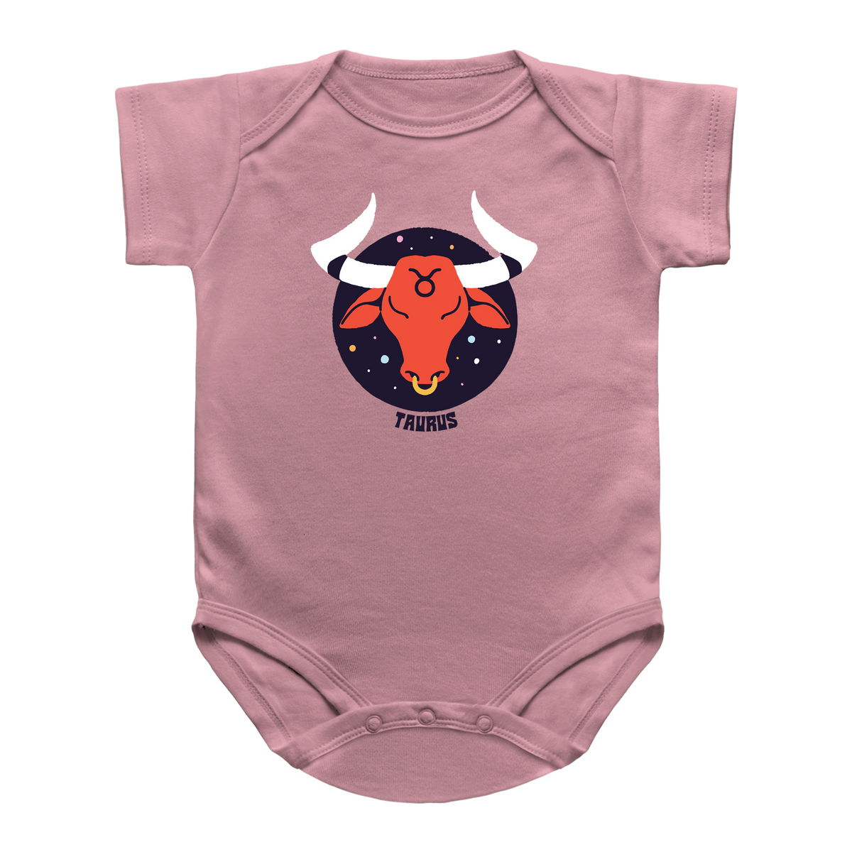 A dusty pink infant onesie featuring a central graphic of a Taurus bull zodiac sign. The graphic shows an orange bull head with white horns inside a dark navy blue circle with white stars, and the word &