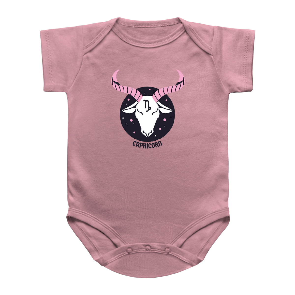 A light pink infant onesie featuring a printed graphic of a Capricorn zodiac sign. The graphic shows a white goat head with pink striped horns inside a black circle with stars, and the word &