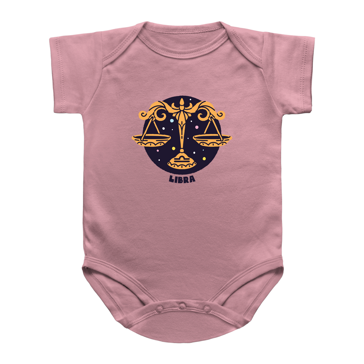 A dusty pink short-sleeve baby bodysuit featuring a Libra zodiac sign graphic on the chest. The graphic depicts the Libra scales of justice in gold against a dark navy blue circular background with stars, and the word &