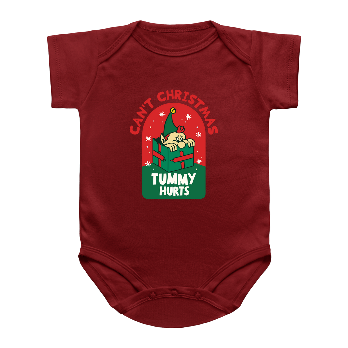 A red baby onesie featuring a Christmas-themed graphic on the chest. The graphic shows a cartoon baby peeking out of a green gift box under the red text &