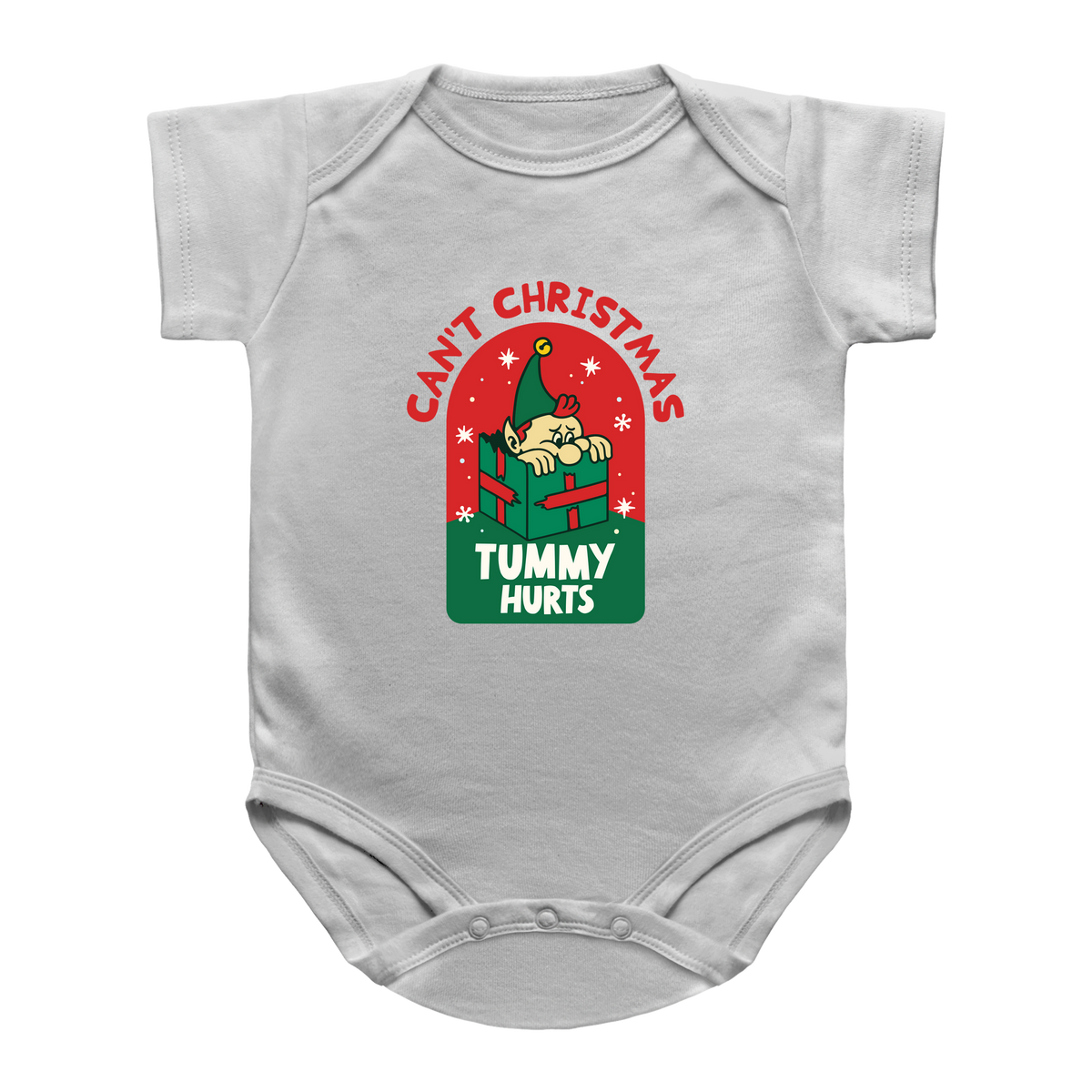 A white infant onesie featuring a Christmas-themed graphic on the chest. The graphic shows a cartoon baby peeking out of a green gift box under the red text &