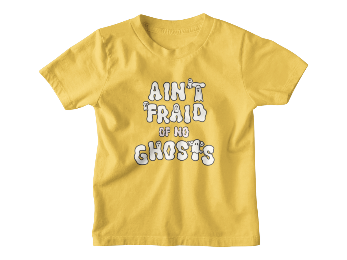 A yellow short-sleeve kid t-shirt with a white graphic Halloween text print that reads &
