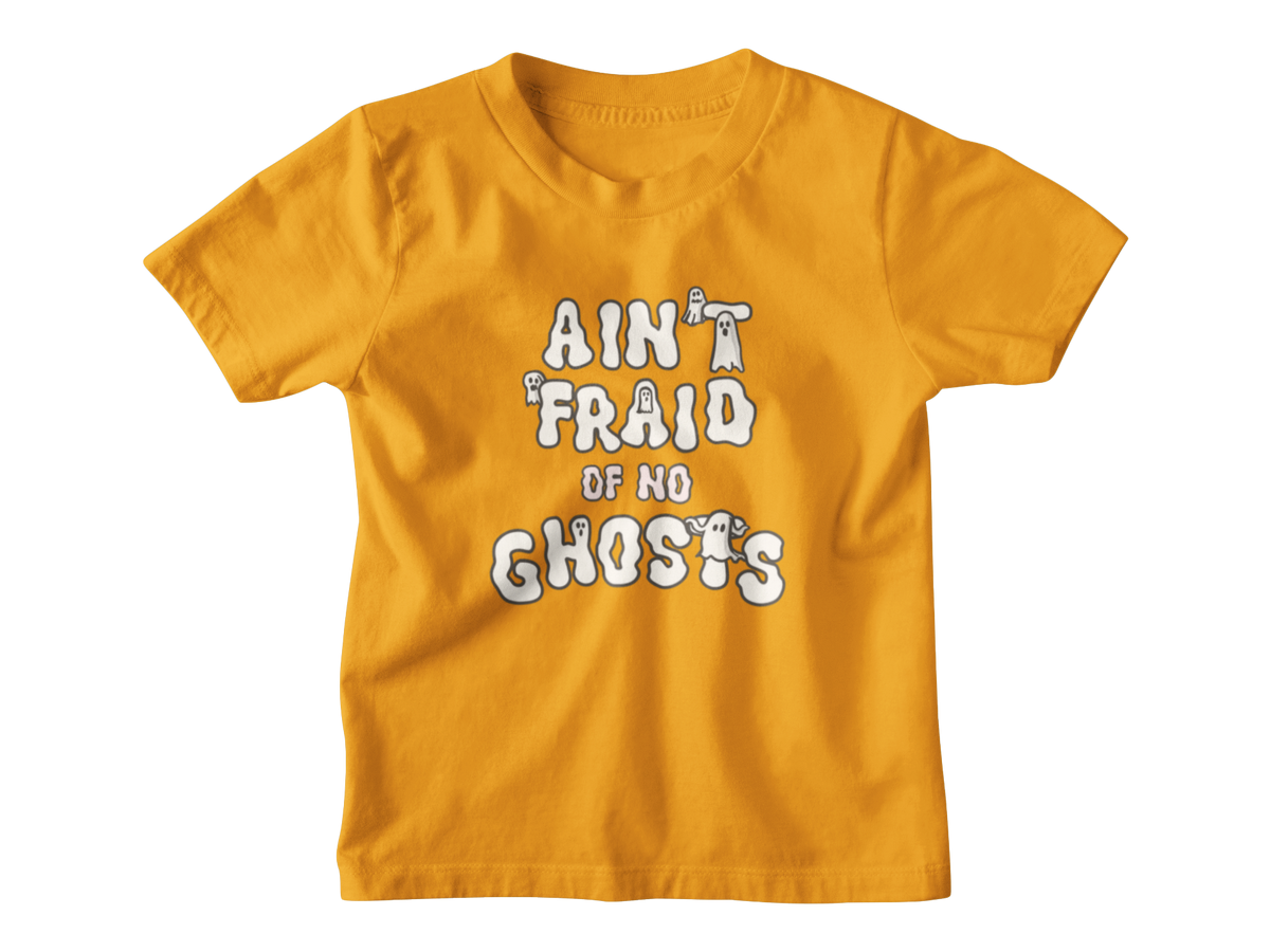 An orange short-sleeve kid t-shirt with a white graphic Halloween text print that reads &