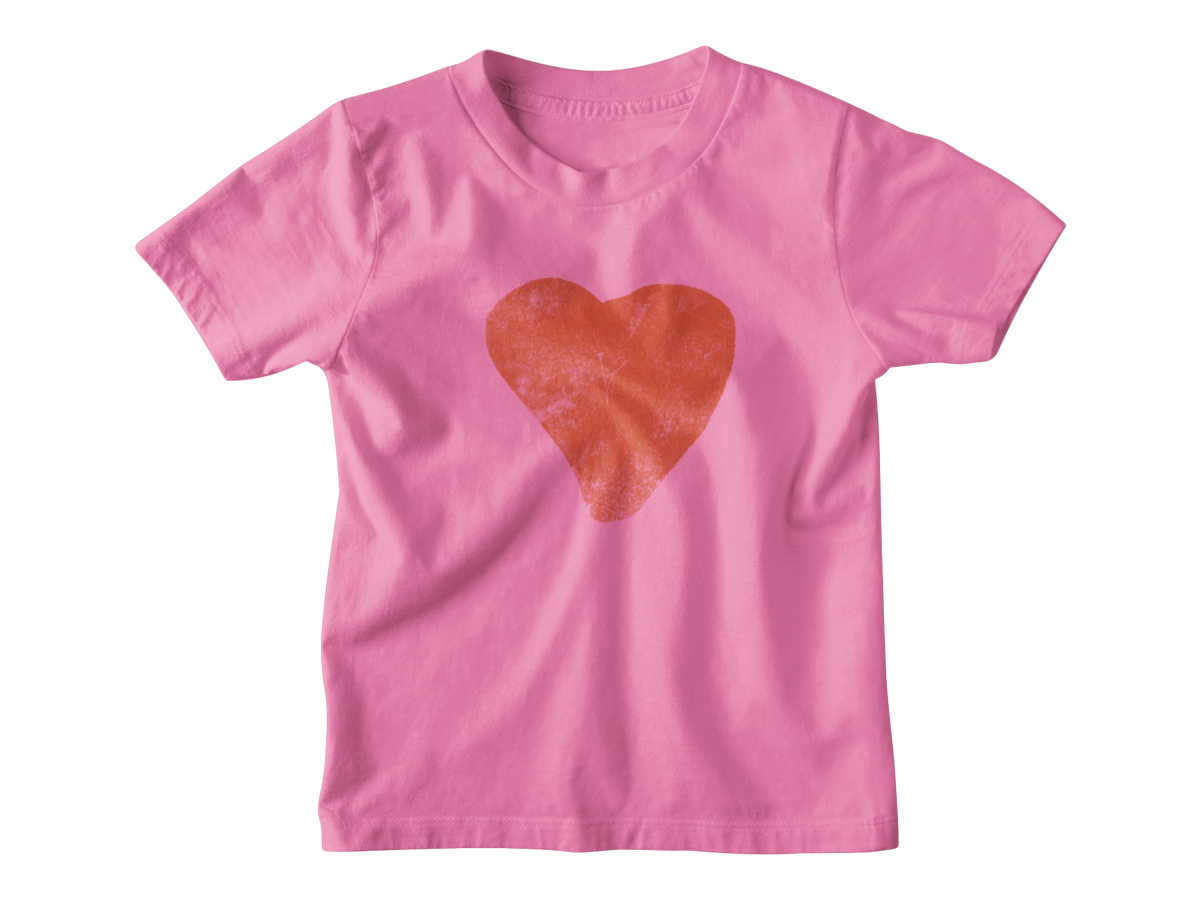 A bright pink short-sleeve kids t-shirt featuring a textured red heart graphic printed on the center chest, meant for Valentine&