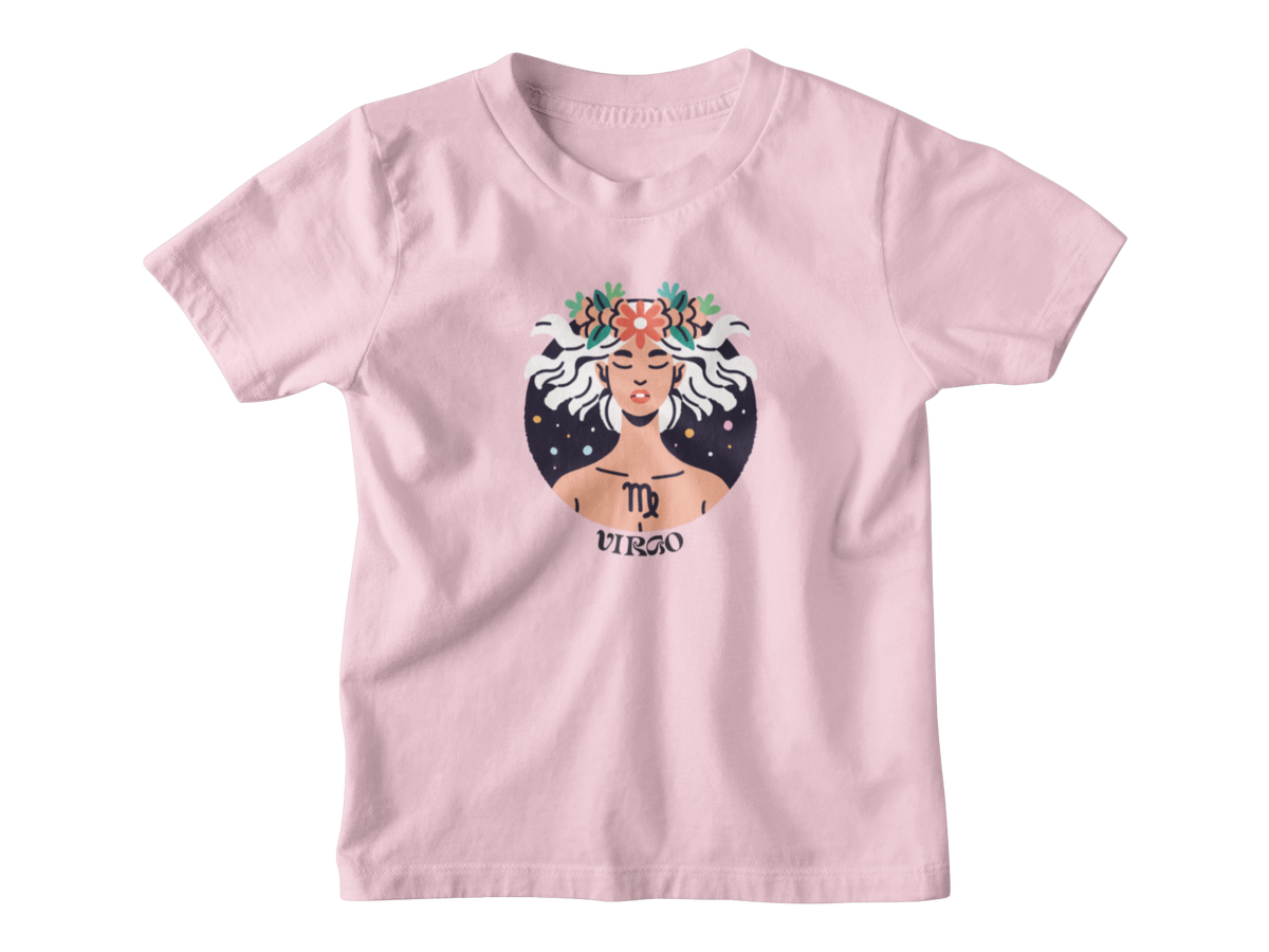 A light pink short-sleeve t-shirt with a graphic of the Virgo zodiac sign, featuring an illustrated figure with white hair, a floral crown, and a starry background.