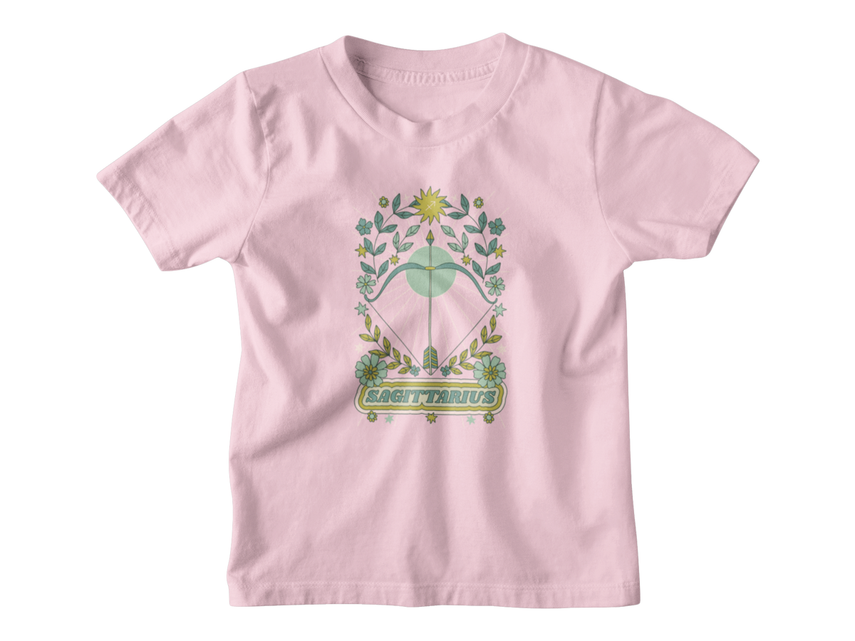 A light pink short-sleeve kids t-shirt with an astrology graphic of a green and gold bow and arrow with floral elements and the word &