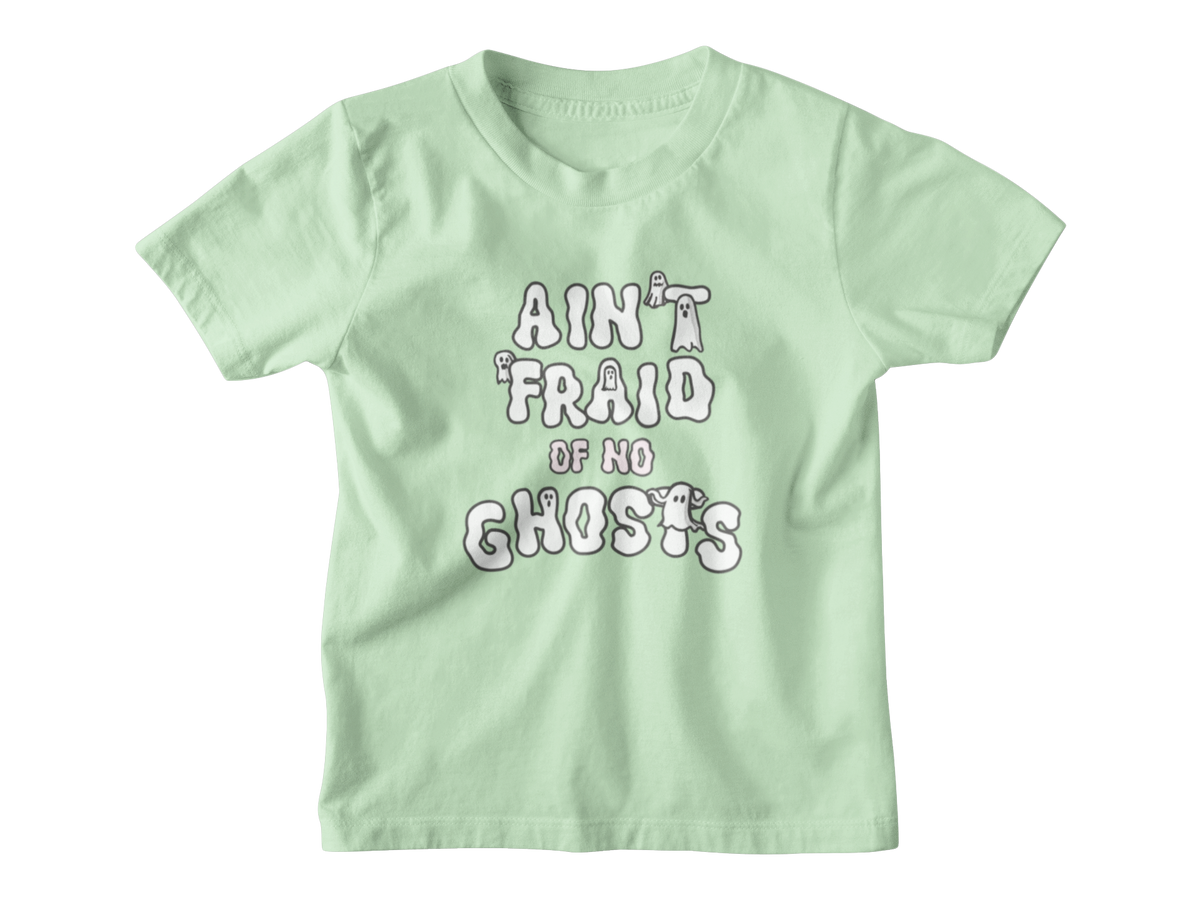 A mint green short-sleeve kid t-shirt with a white graphic Halloween text print that reads &