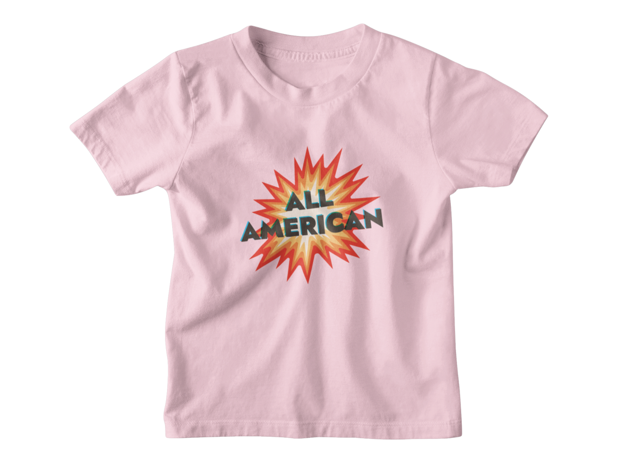 A light pink short-sleeve kids t-shirt with a graphic on the chest featuring a 4th of July firework with the text &
