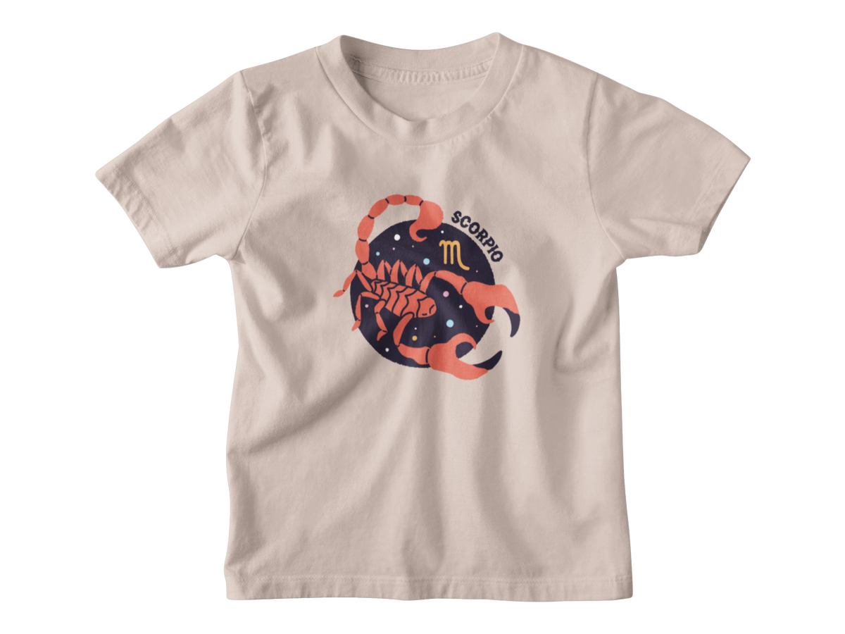 A beige short-sleeve kids astrology t-shirt with a graphic of a scorpion inside a starry circle, featuring the word &