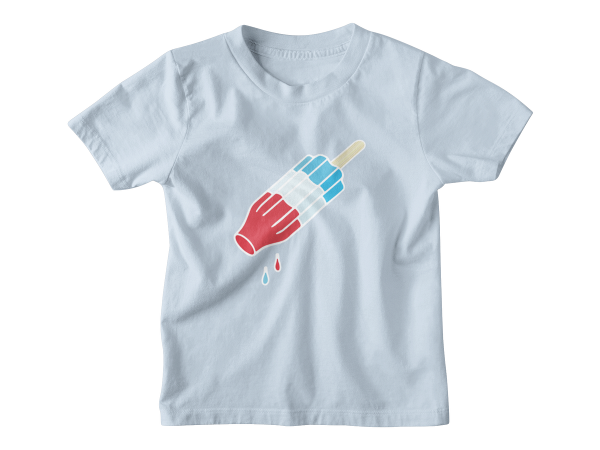 A light blue short-sleeve kids crewneck t-shirt featuring a graphic of a rocket popsicle with blue and white stripes for 4th of July.