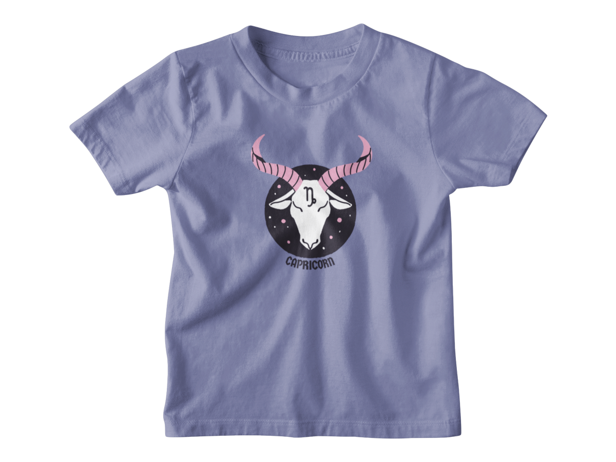 A light periwinkle blue short-sleeve t-shirt with a central graphic of a Capricorn zodiac symbol featuring a black circle, white goat head, and pink horns.