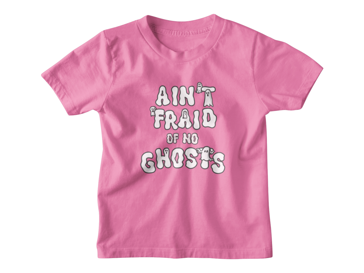 A pink short-sleeve kid t-shirt with a white graphic Halloween text print that reads &
