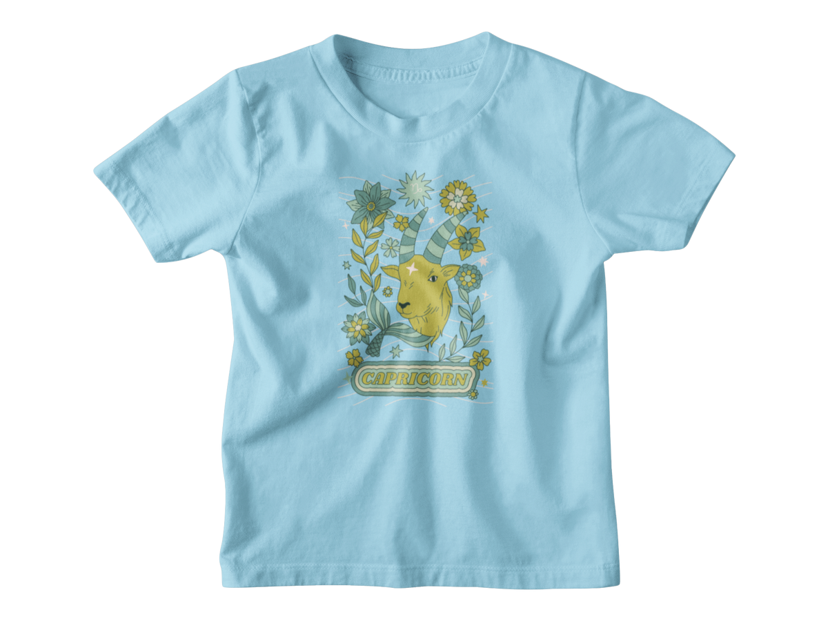 A blue kids shirt for Capricorn astrology sign with a tarot goat.
