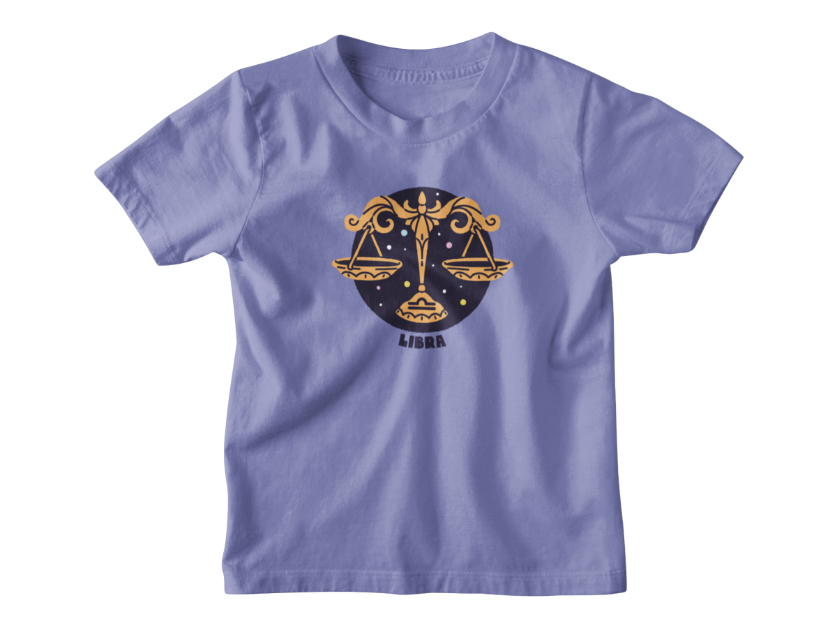 A light purple short-sleeve t-shirt with a Libra zodiac graphic on the chest, featuring a gold scale of justice design over a dark blue circle with the word &