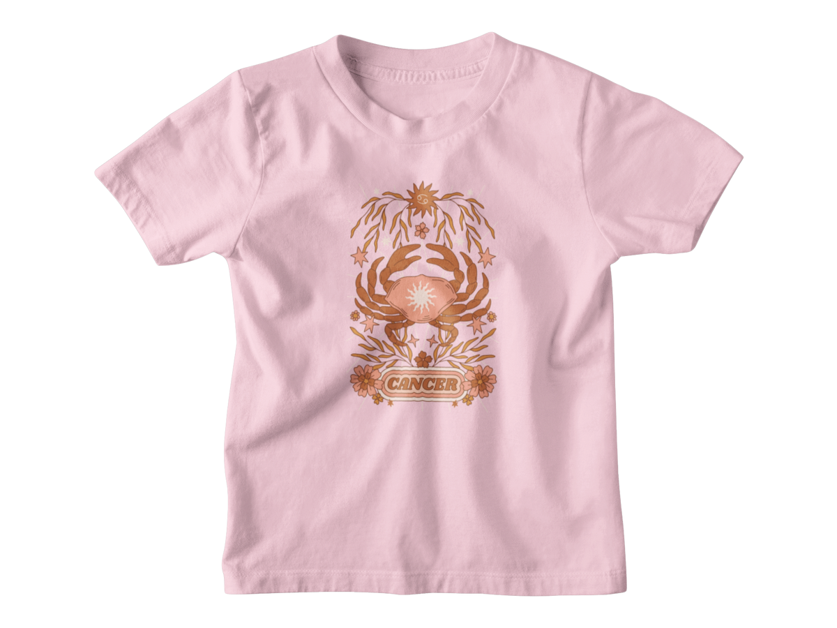 A light pink short-sleeve kids t-shirt featuring a central graphic of a Cancer zodiac symbol in a bronze/copper color, displayed on a clean white background.