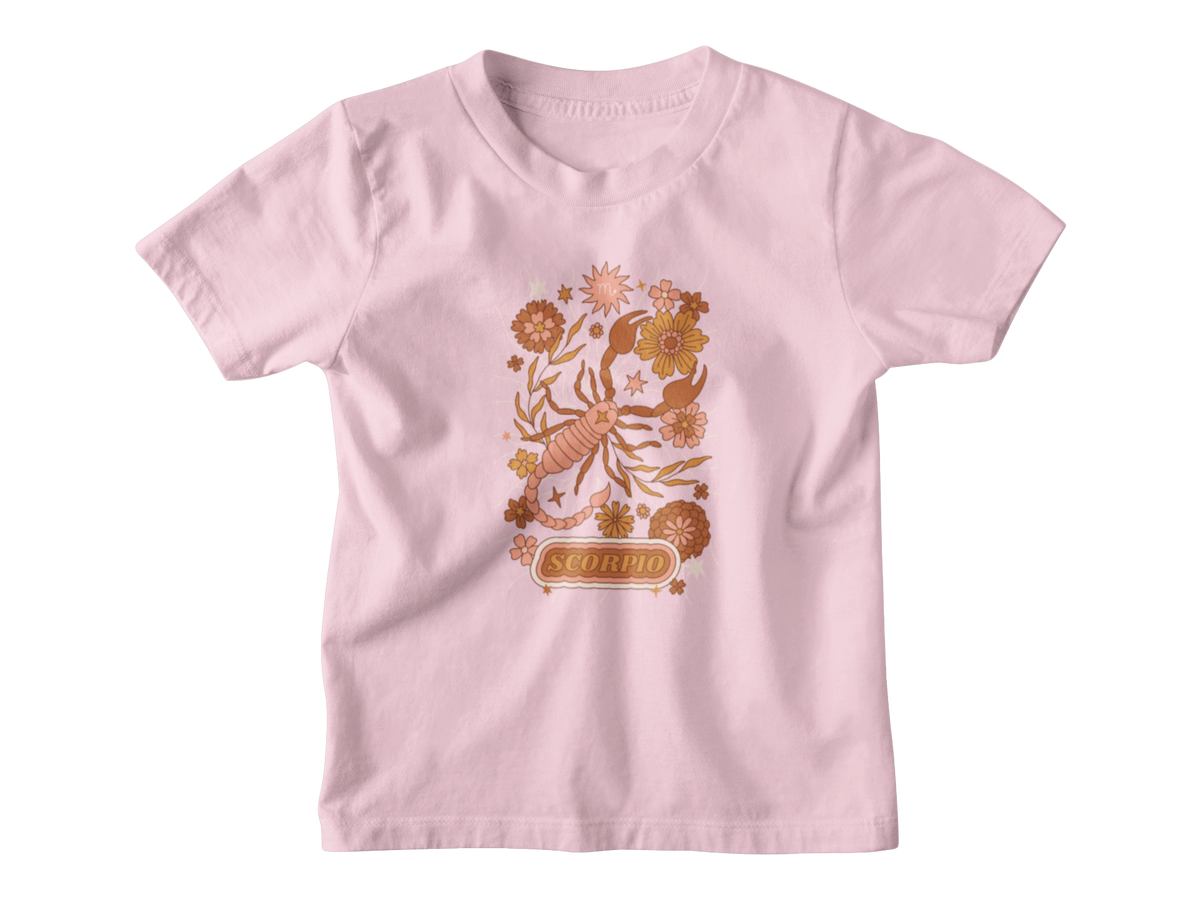 A pink short-sleeve kids astrology t-shirt with a colorful Scorpio zodiac graphic featuring a scorpion, flowers, and the word &
