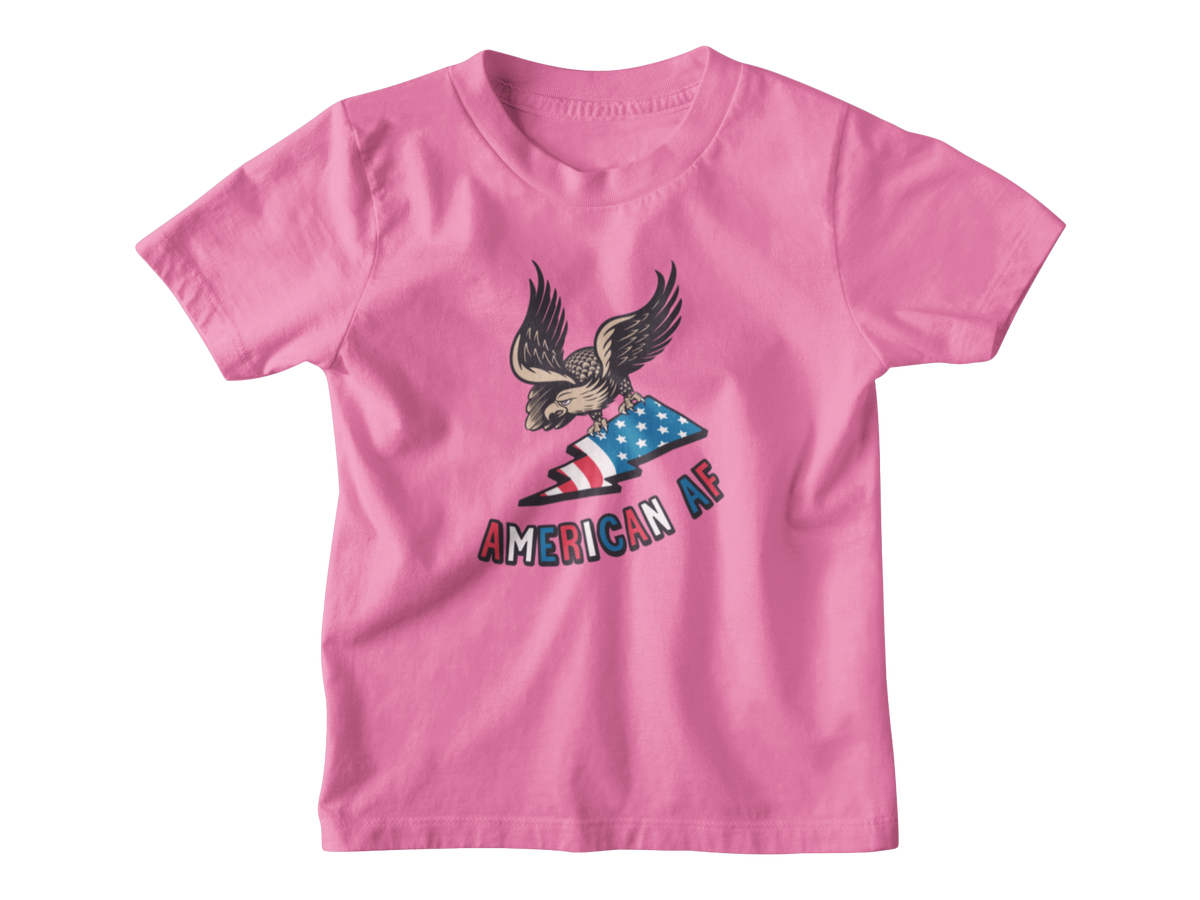 A pink short-sleeve t-shirt with a graphic of an eagle holding an American flag and the text &