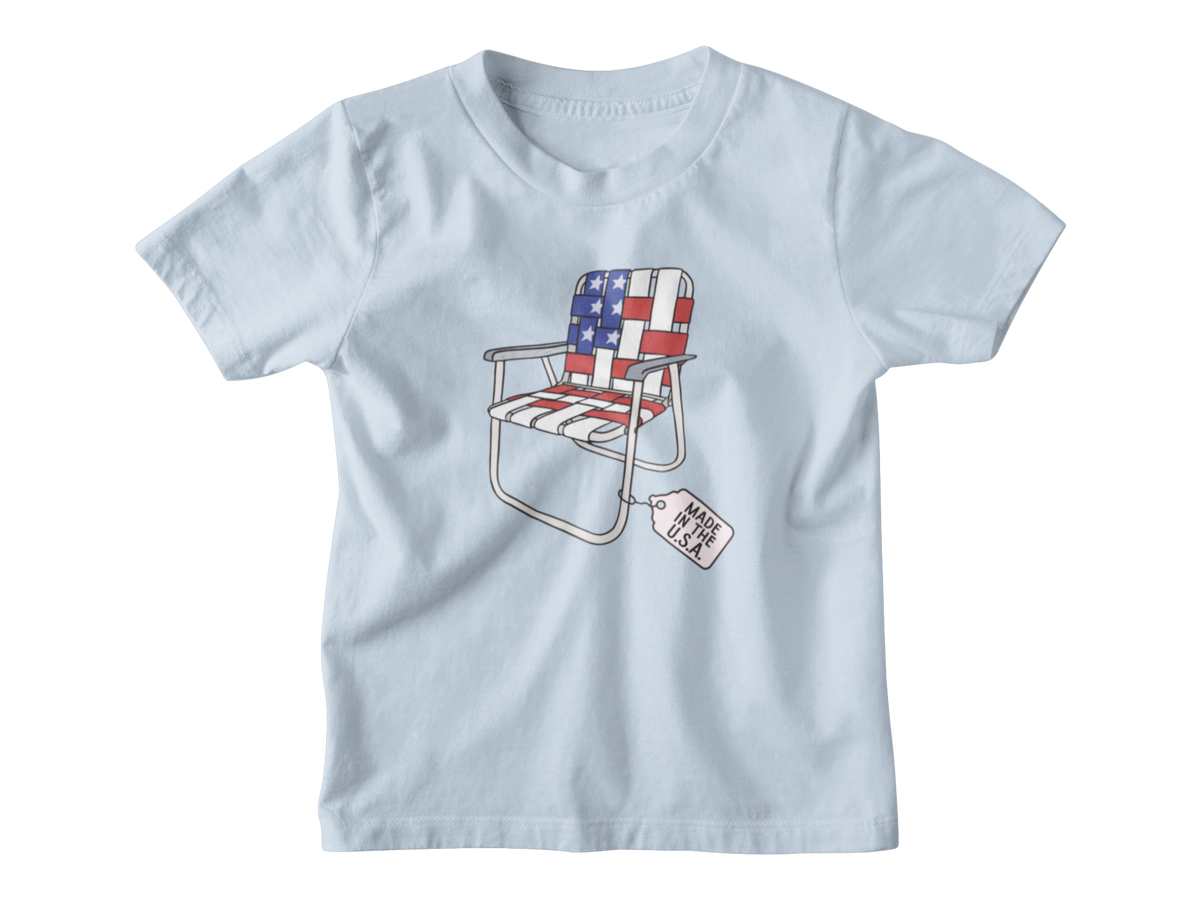 A blue short-sleeve kids t-shirt for 4th of July with a folding lawn chair featuring an American flag pattern, with a &