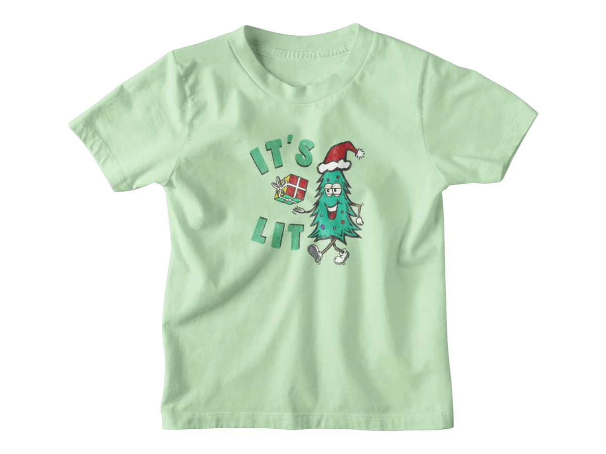 A light mint green short-sleeve t-shirt with a cartoon graphic on the front. The graphic features a green Christmas tree character wearing a red Santa hat and walking next to the text &