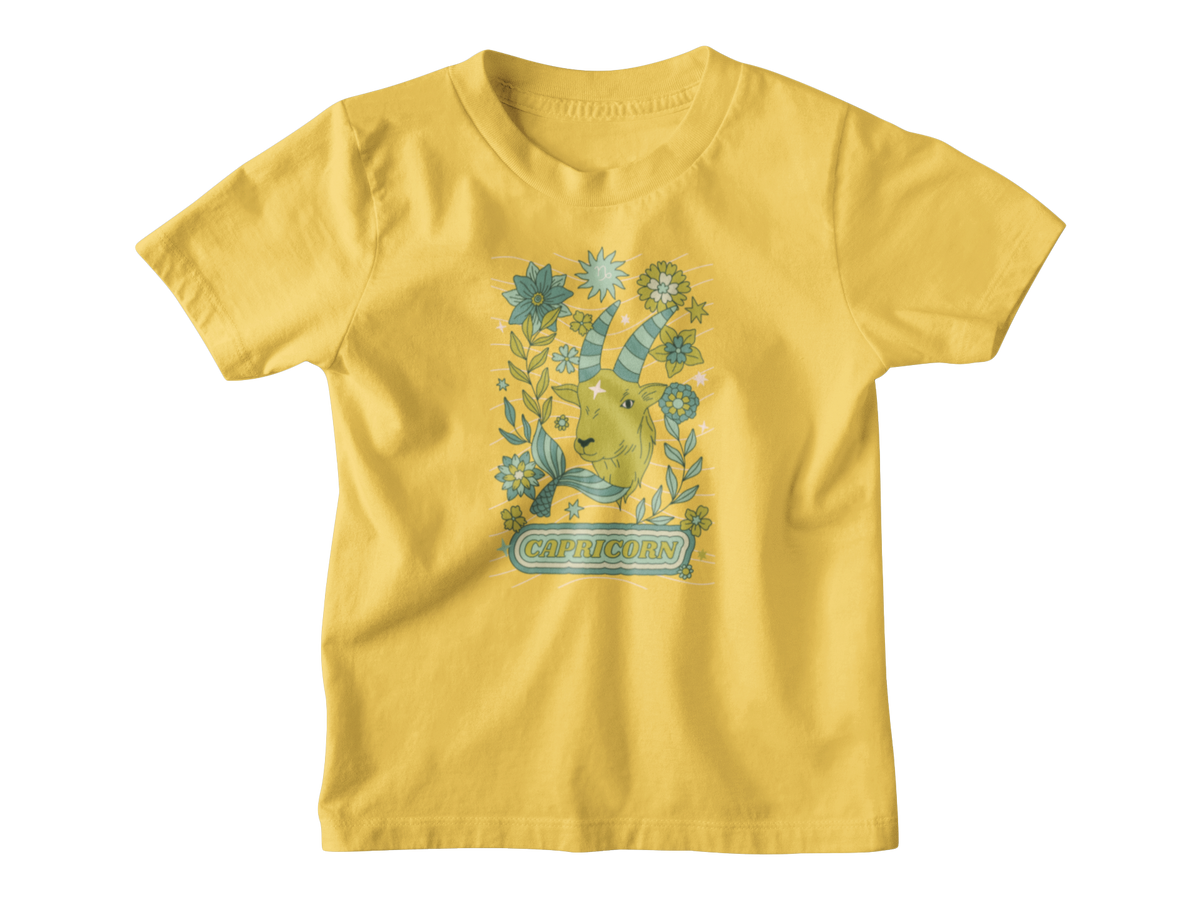 A yellow kids shirt for Capricorn astrology sign with a tarot goat.