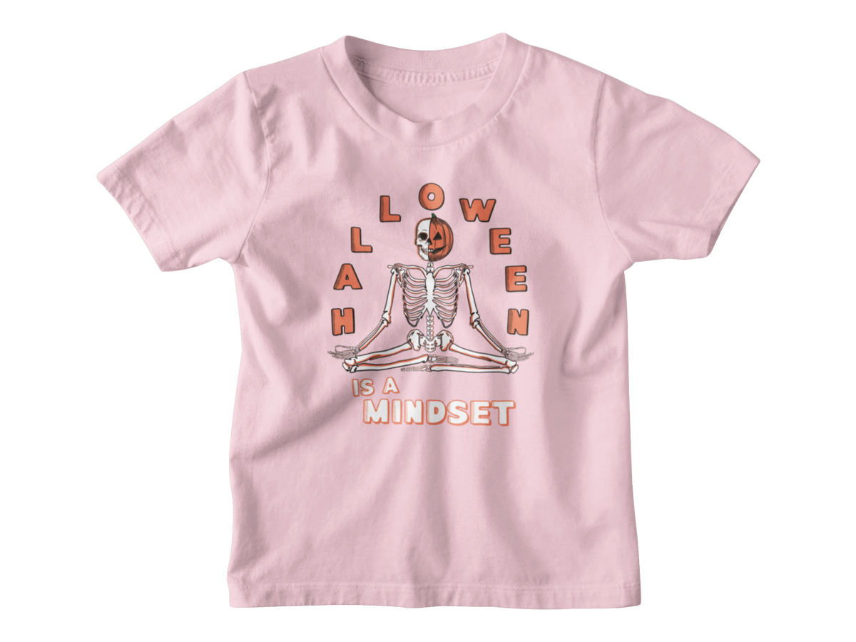 A pink short-sleeve kids Halloween t-shirt with a graphic on the front showing a skeleton meditating inside a jack-o&