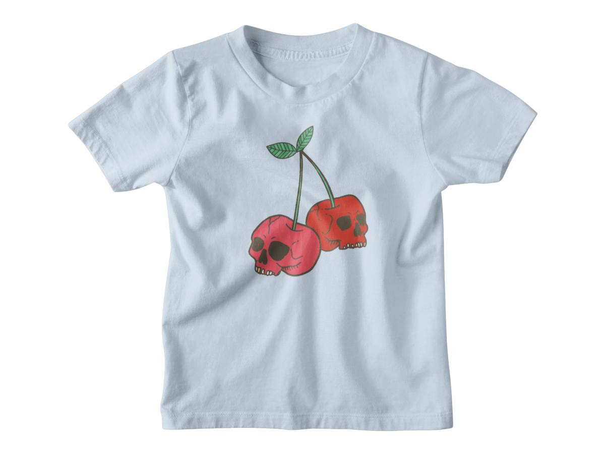 A light blue short-sleeve kids t-shirt featuring a graphic of two red cherries with skull faces and green stems, displayed on a clean white background.