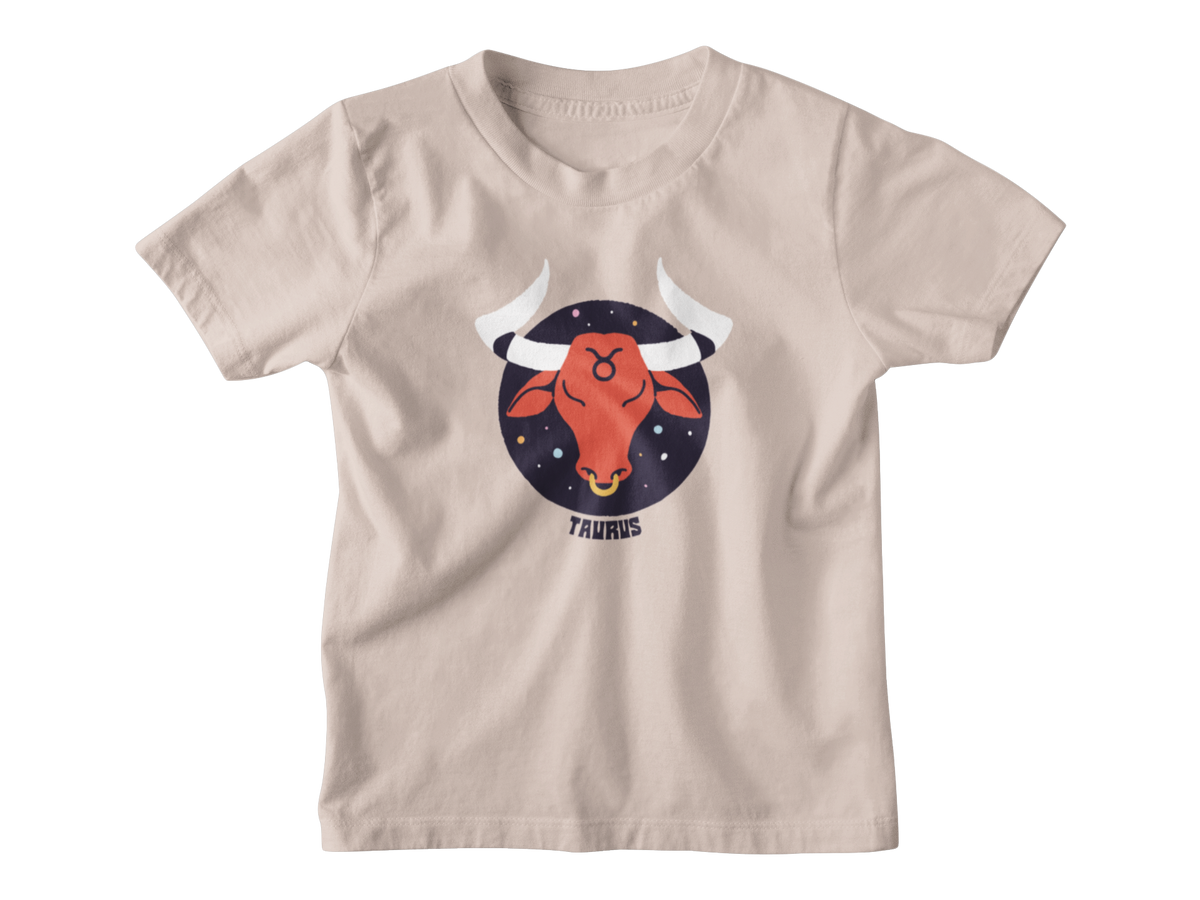 A tan short-sleeve kids t-shirt with a graphic of a red bull head inside a dark blue starry circle, labeled &