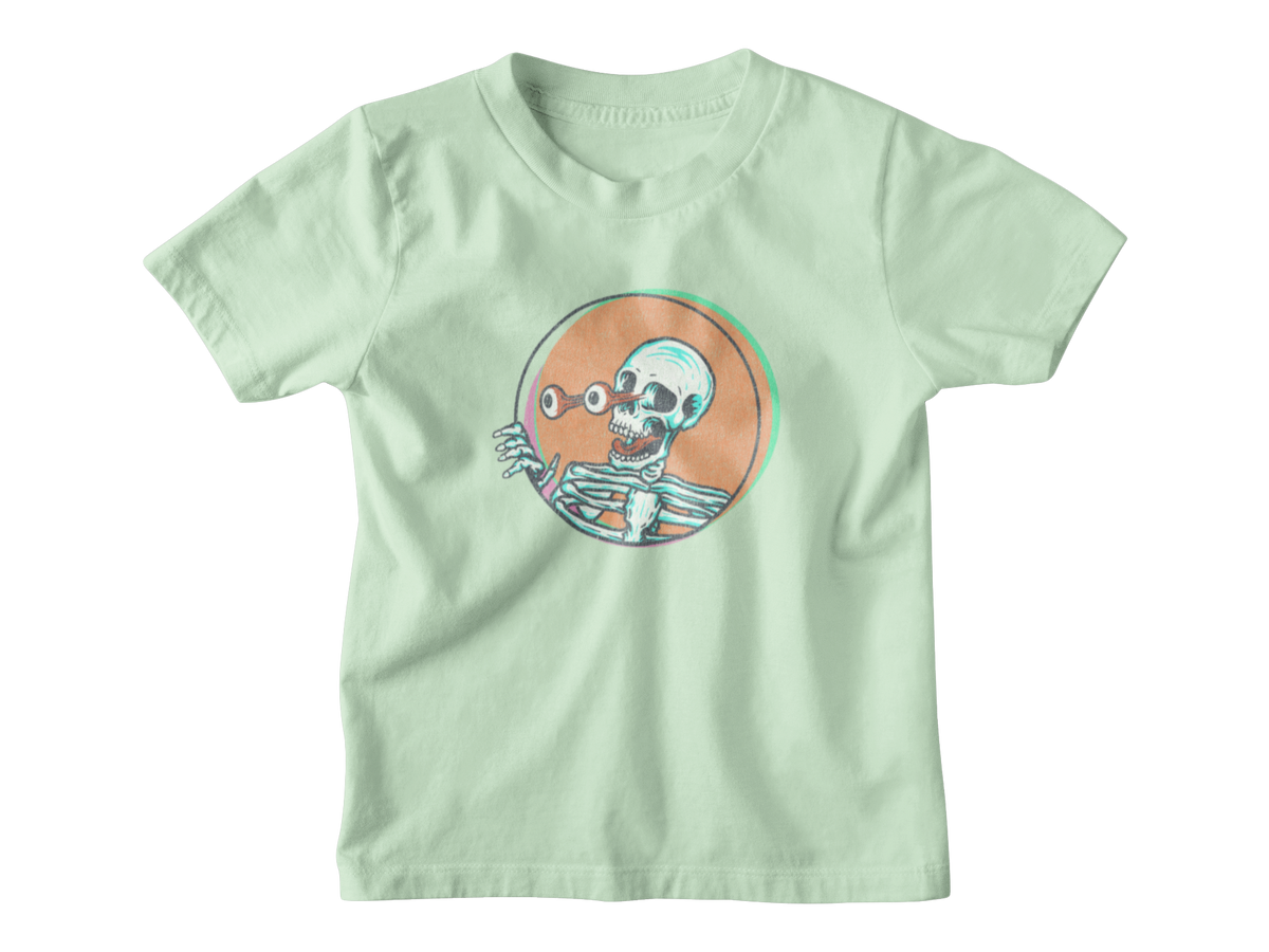 A light mint green short-sleeve t-shirt with a cartoon skeleton graphic inside an orange circle on the chest, displayed flat against a white background.
