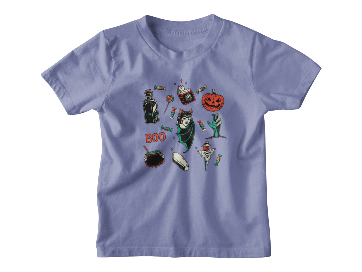 A light periwinkle blue kids short-sleeve t-shirt with a central graphic collage of various Halloween-themed illustrations, including a jack-o&