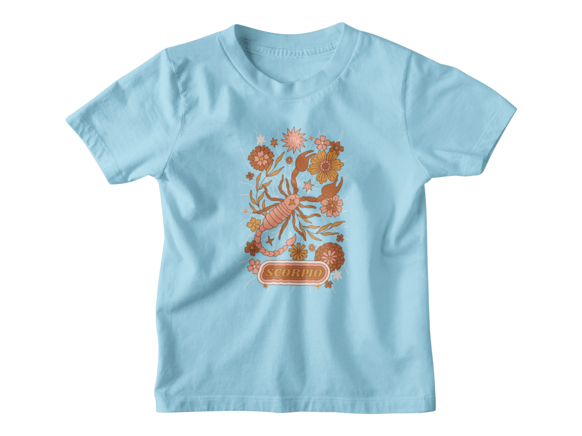A light blue short-sleeve kids astrology t-shirt with a colorful Scorpio zodiac graphic featuring a scorpion, flowers, and the word &