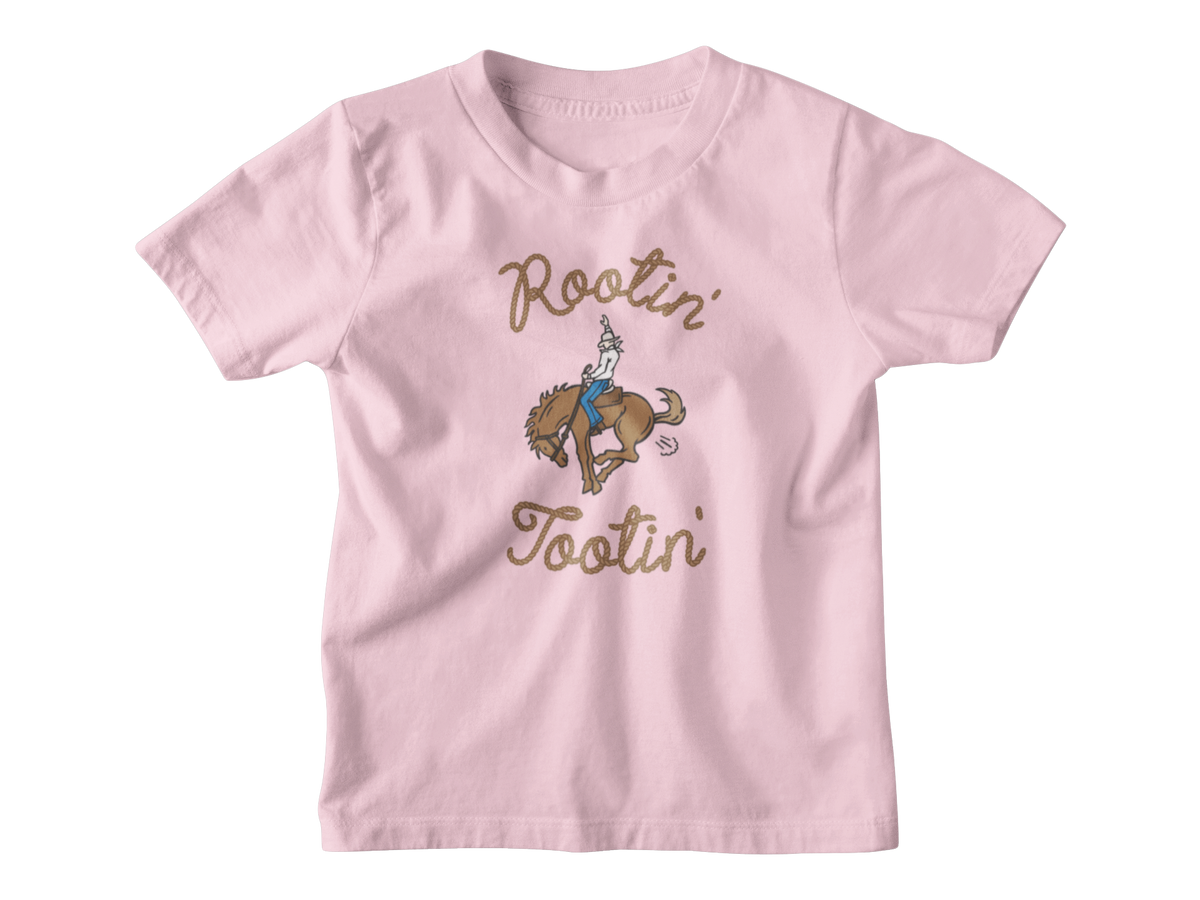 A pink kids short-sleeve t-shirt with a graphic of a cowboy riding a bucking horse, surrounded by the words &