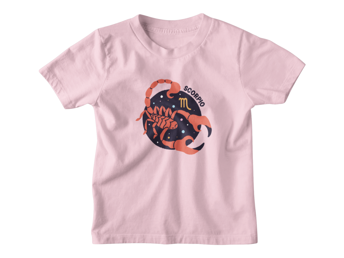 A light pink short-sleeve kids astrology t-shirt with a graphic of a scorpion inside a starry circle, featuring the word &
