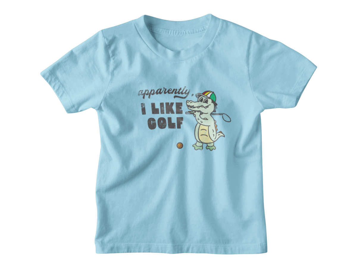 A light blue short-sleeve t-shirt with a cartoon graphic of a crocodile playing golf and the text &