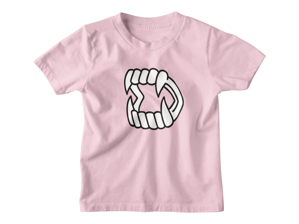 A pink short-sleeve kids t-shirt with a white cartoon graphic of Halloween vampire fangs on the chest, displayed on a solid white background.