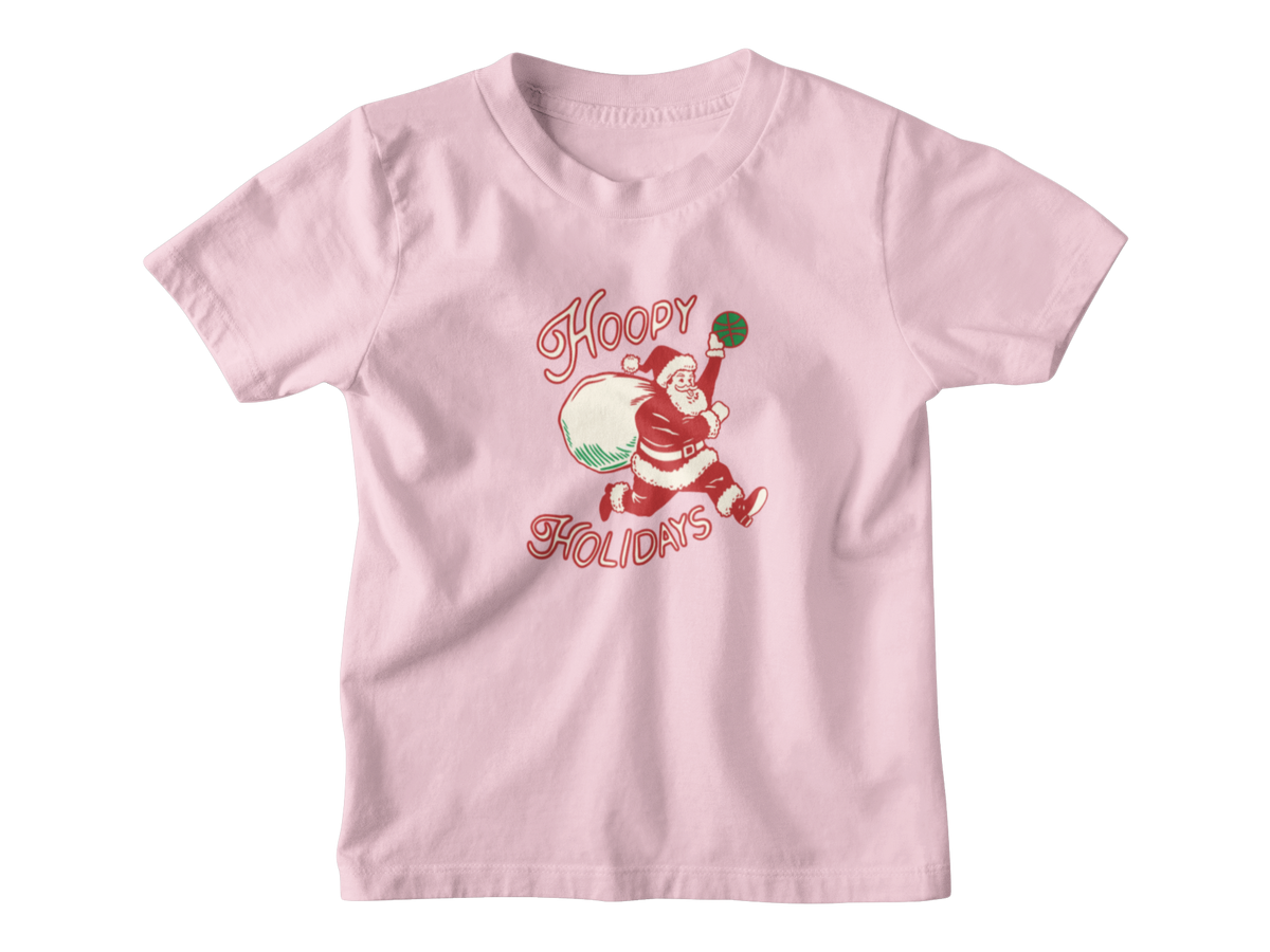 A pink short-sleeve t-shirt with a vintage-style Christmas graphic of Santa Claus running while carrying a sack, with the words &