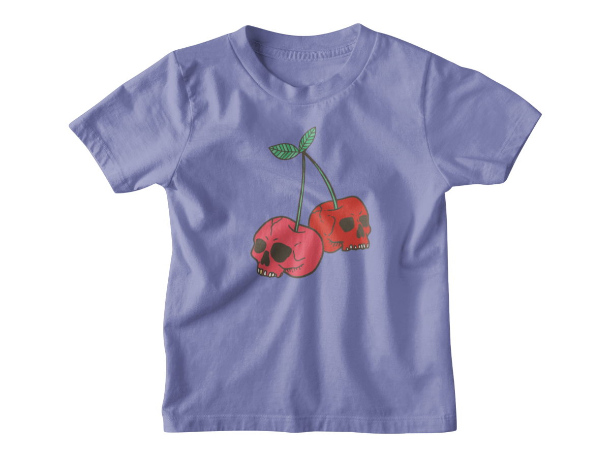 A violet short-sleeve kids t-shirt featuring a graphic of two red cherries with skull faces and green stems, displayed on a clean white background.