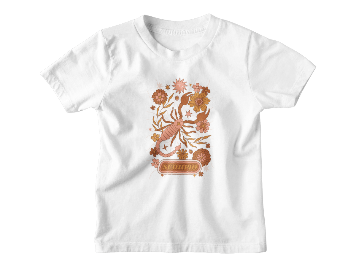 A white short-sleeve kids astrology t-shirt with a colorful Scorpio zodiac graphic featuring a scorpion, flowers, and the word &