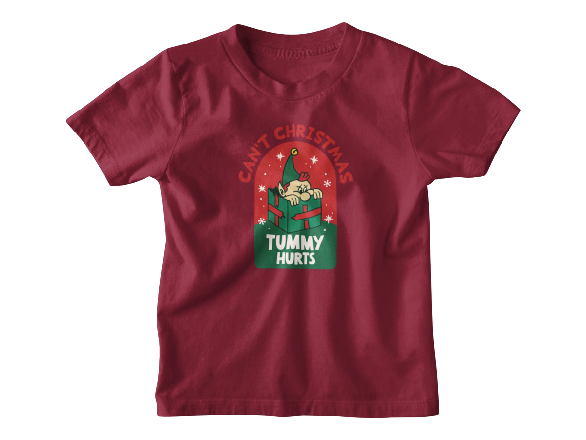 A red kids t-shirt with a Christmas-themed graphic on the chest. The graphic features a cartoon character in a green hat holding a red gift box under the text &