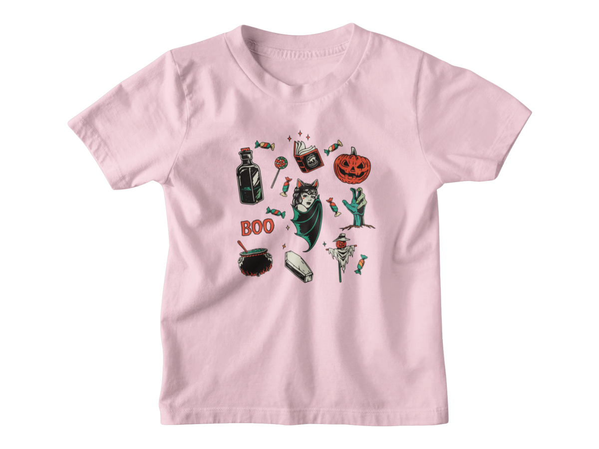A pink kids short-sleeve t-shirt with a central graphic collage of various Halloween-themed illustrations, including a jack-o&