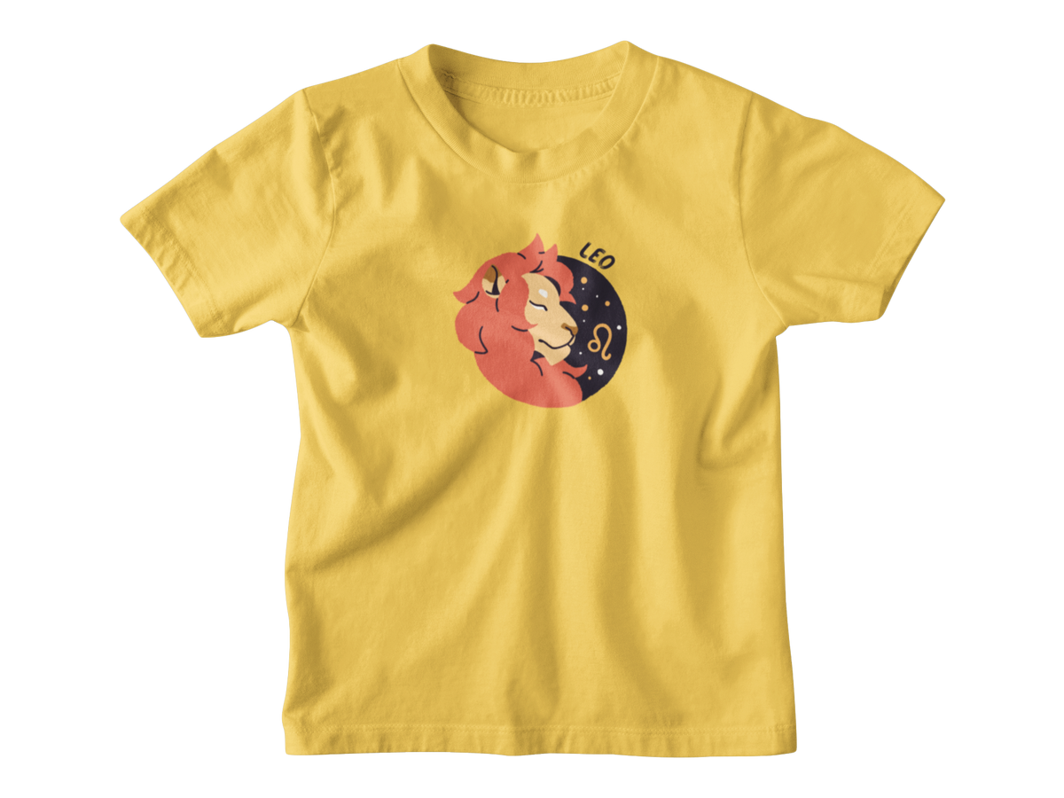 A yellow short-sleeve crewneck t-shirt featuring a cartoon graphic of a Leo zodiac sign, showing a sleeping orange lion resting on a dark blue crescent moon with stars and the text &
