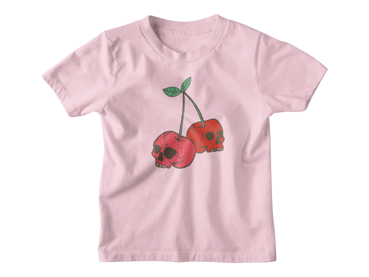 A pink short-sleeve kids t-shirt featuring a graphic of two red cherries with skull faces and green stems, displayed on a clean white background.