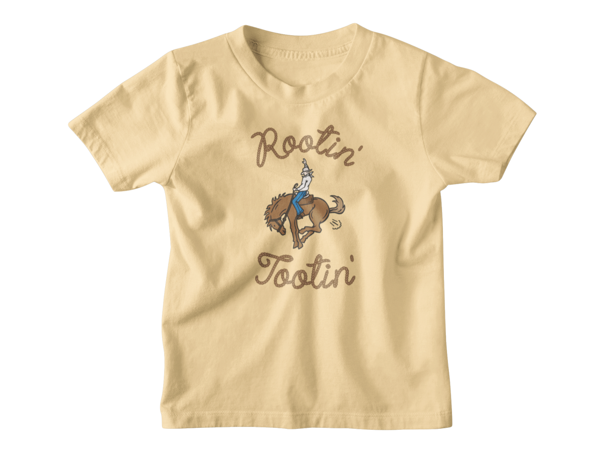 A yellow kids short-sleeve t-shirt with a graphic of a cowboy riding a bucking horse, surrounded by the words &