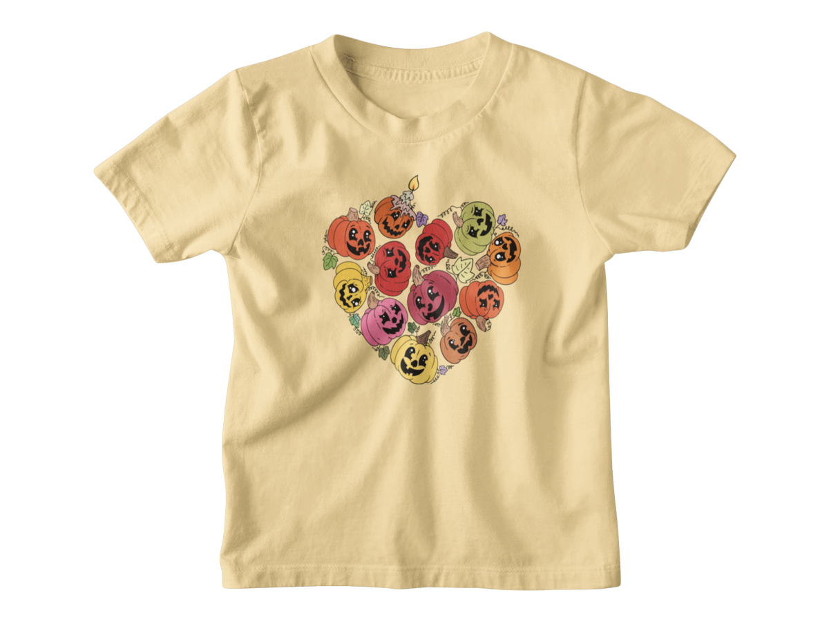 A light yellow short-sleeve kids t-shirt with a heart-shaped graphic of smiling jack-o&