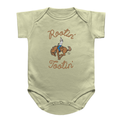 A natural color short-sleeve infant onesie with a graphic of a cowboy riding a bucking horse, farting and the words Rootin&