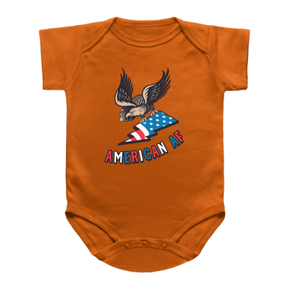 A orange short-sleeve baby onesie for 4th of July featuring a graphic of an eagle holding an American flag with the text &