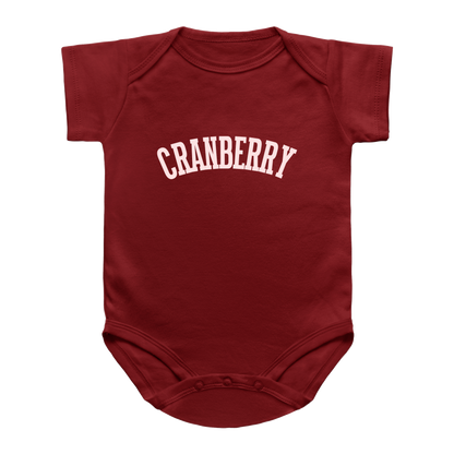 A short-sleeve infant onesie in dark red with the word &