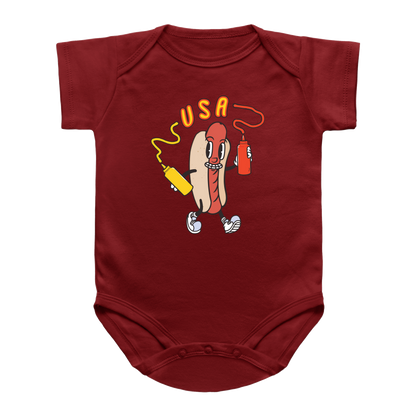 A red 4th of July short-sleeve infant onesie featuring a hot dog holding a yellow mustard bottle and a red ketchup bottle, with the word &