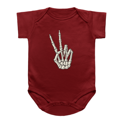 A red short-sleeve infant onesie featuring a skeleton hand graphic making a peace sign on the chest.